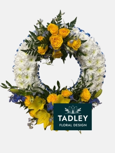 Wreath Based With White Flower With Yellow Spray & Blue Ribbon